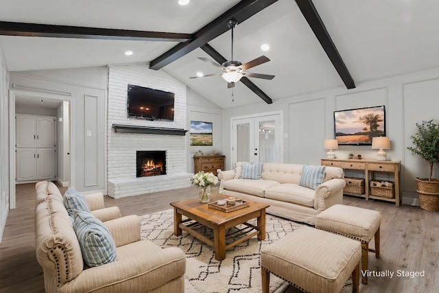 1206 Mayapple Dr, Garland, TX 75043 - living room featuring vaulted ceiling with beams, light wood-style flooring, ceiling fan, and a decorative wall