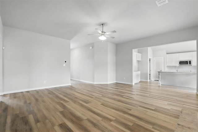 116 Mesa Dr, Glen Rose, TX 76043 - unfurnished living room featuring a ceiling fan, light wood-type flooring, and baseboards