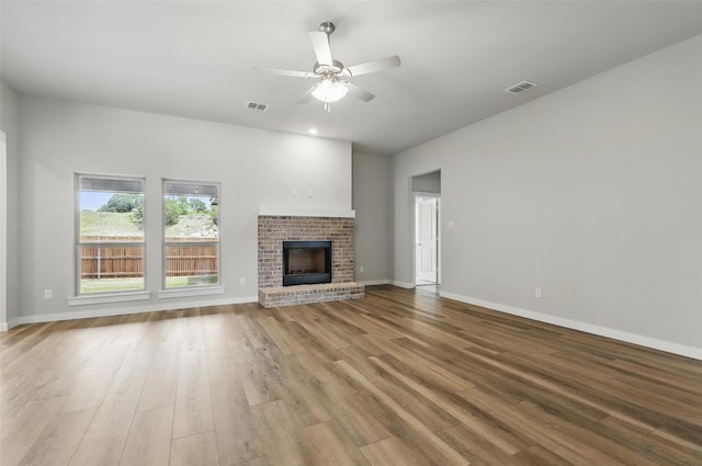 116 Mesa Dr, Glen Rose, TX 76043 - unfurnished living room with wood finished floors, ceiling fan, baseboards, and a fireplace