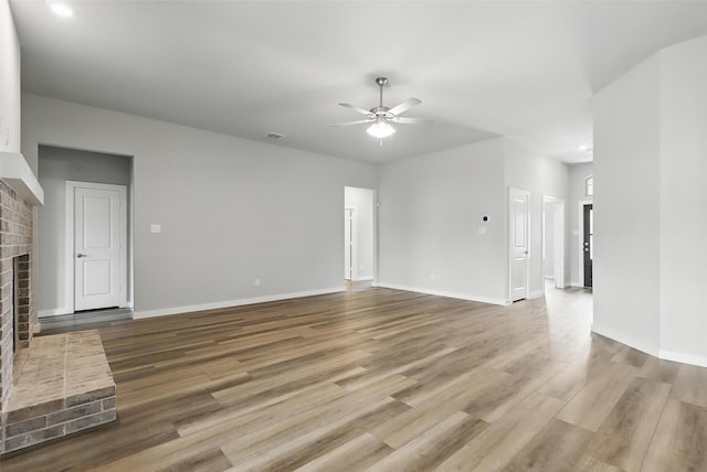 116 Mesa Dr, Glen Rose, TX 76043 - unfurnished living room featuring a brick fireplace, a ceiling fan, and wood finished floors