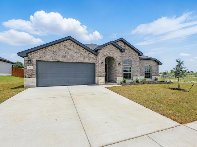 116 Mesa Dr, Glen Rose, TX 76043 - french country style house with brick siding, concrete driveway, and an attached garage