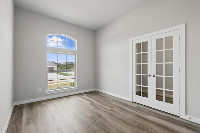 116 Mesa Dr, Glen Rose, TX 76043 - spare room with french doors, wood finished floors, and baseboards