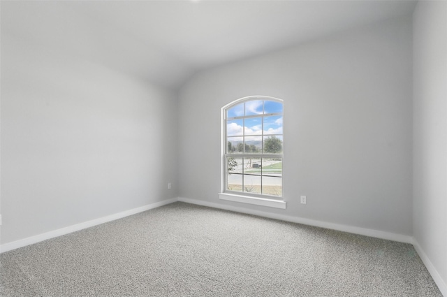 116 Mesa Dr, Glen Rose, TX 76043 - empty room featuring light carpet, vaulted ceiling, and baseboards