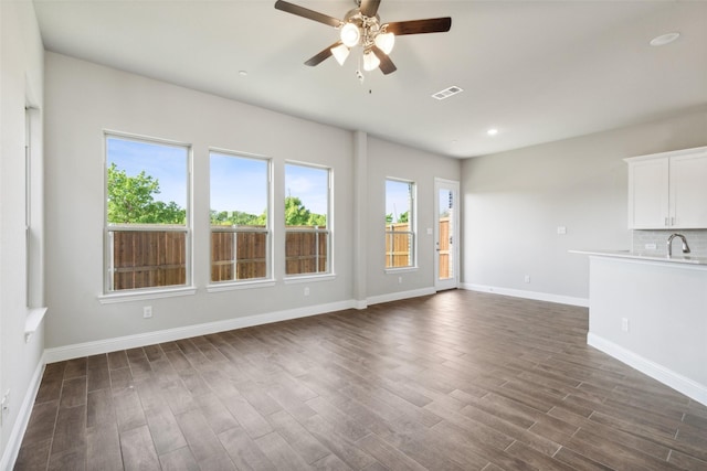 3144 Galveston St, Plano, TX 75075 - unfurnished living room featuring ceiling fan, dark wood-type flooring, baseboards, and recessed lighting
