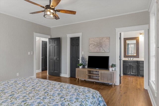 bedroom with ornamental molding, baseboards, a sink, a ceiling fan, and wood finished floors