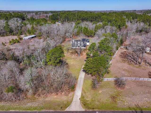 birds eye view of property with a forest view