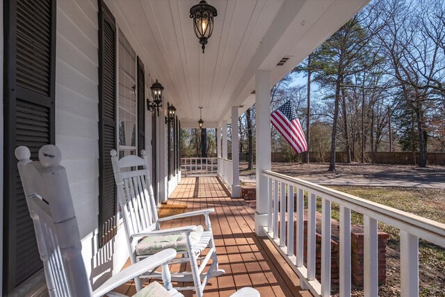 wooden deck with visible vents and a porch