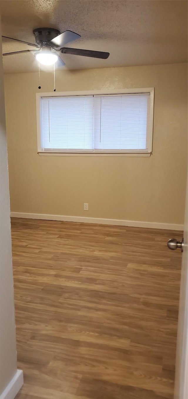 425 Oxford Dr, Sherman, TX 75092 - empty room featuring baseboards, light wood-style floors, a textured ceiling, and ceiling fan
