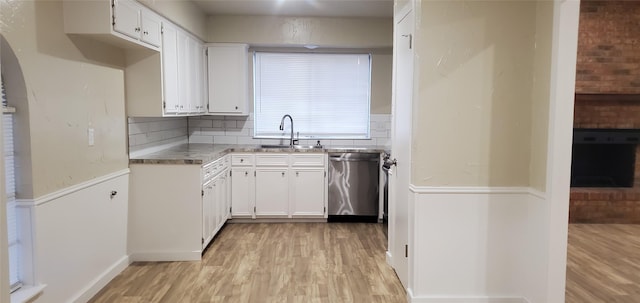 425 Oxford Dr, Sherman, TX 75092 - kitchen with white cabinets, decorative backsplash, a sink, dishwasher, and light wood-style flooring