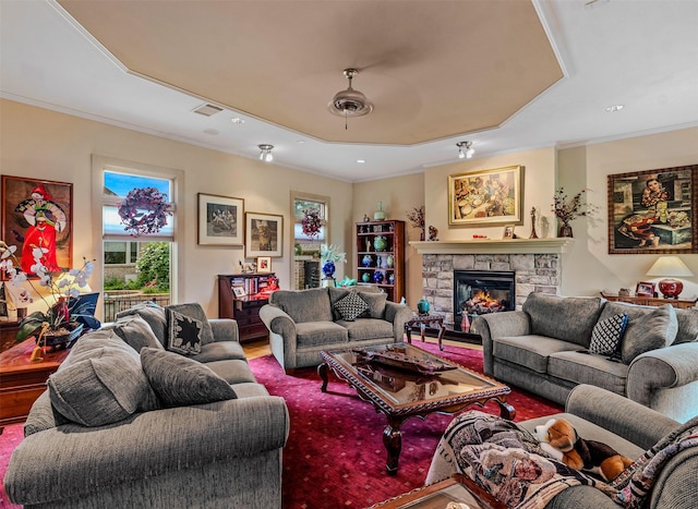 living room with a fireplace, ornamental molding, visible vents, and recessed lighting