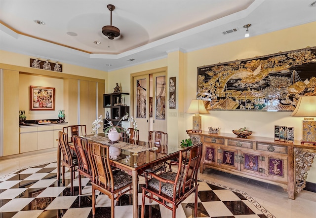 dining space featuring a raised ceiling and visible vents