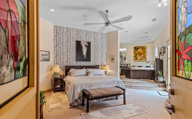bedroom featuring wallpapered walls, an accent wall, light colored carpet, visible vents, and ornamental molding