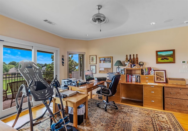 office area featuring a ceiling fan, crown molding, light wood-style floors, and visible vents