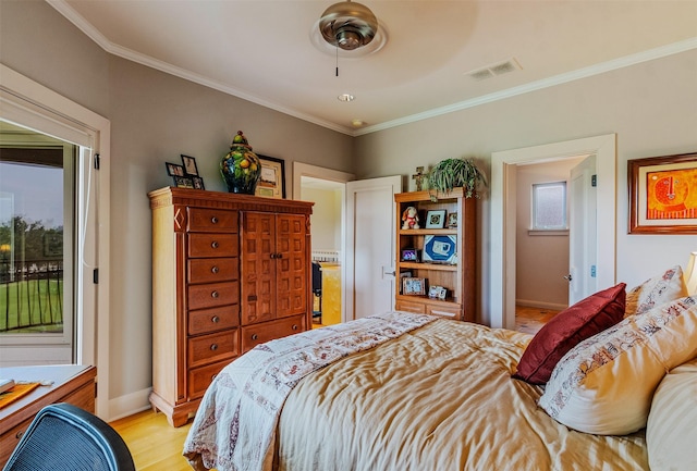 bedroom featuring visible vents, crown molding, light wood-style floors, and access to outside
