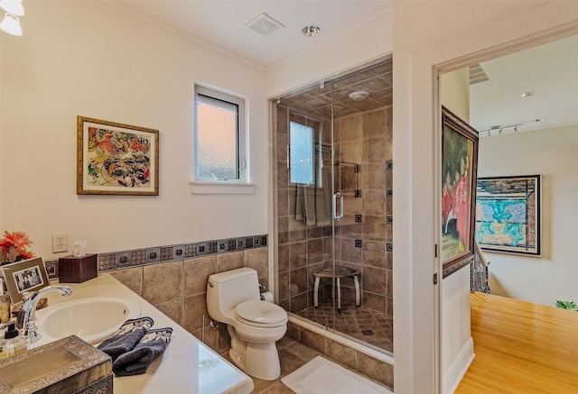 full bathroom with tile walls, visible vents, crown molding, toilet, and a stall shower