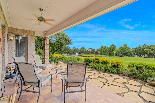 view of patio with ceiling fan and a fire pit