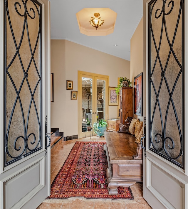 entrance foyer featuring baseboards, crown molding, tile patterned flooring, and french doors