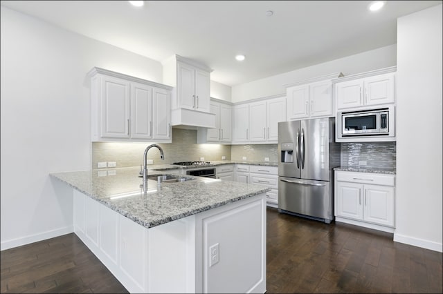 kitchen featuring dark wood-type flooring, a sink, white cabinets, and stainless steel appliances