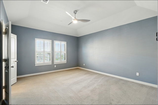 spare room with carpet flooring, a ceiling fan, baseboards, and vaulted ceiling