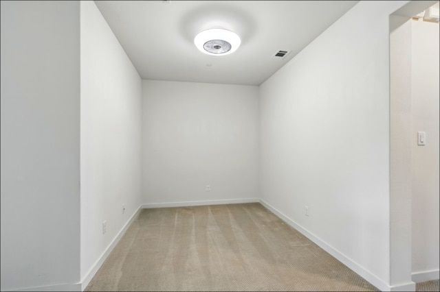 empty room with light colored carpet, baseboards, and visible vents
