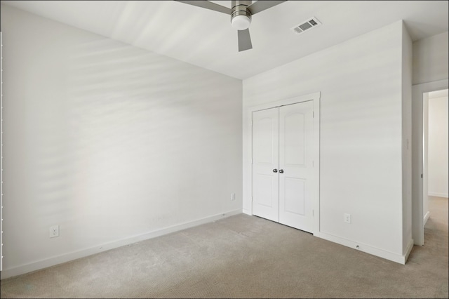 unfurnished bedroom with visible vents, carpet flooring, baseboards, and a closet