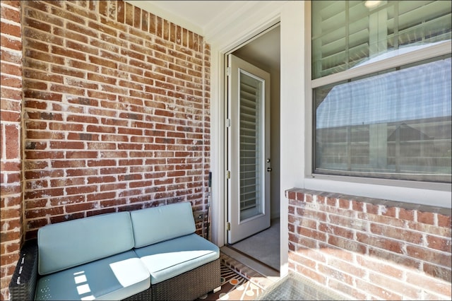 doorway to property featuring brick siding