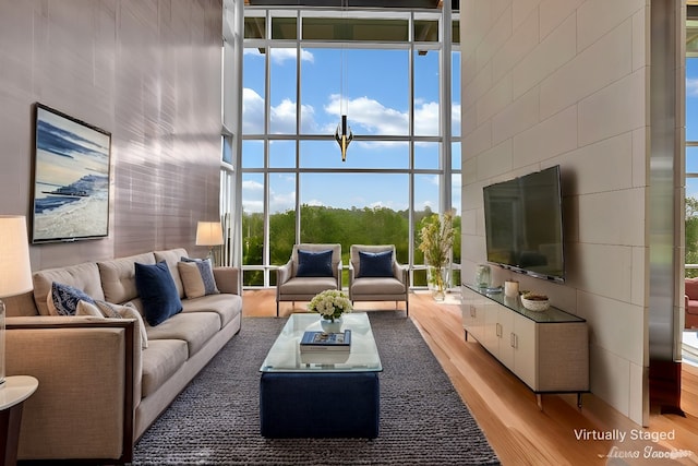613 Moore Rd, Elm Grove, LA 71051 - living room featuring light wood-style floors, floor to ceiling windows, and a towering ceiling