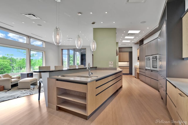 613 Moore Rd, Elm Grove, LA 71051 - kitchen featuring modern cabinets, light brown cabinets, a sink, open shelves, and light wood-type flooring