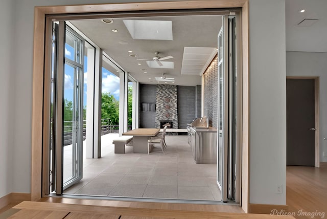 613 Moore Rd, Elm Grove, LA 71051 - hallway featuring a skylight, baseboards, and a wall of windows