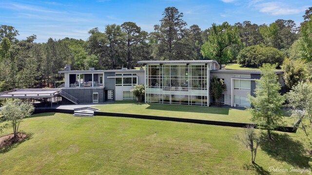 613 Moore Rd, Elm Grove, LA 71051 - back of property with a sunroom, stairway, a yard, and stucco siding
