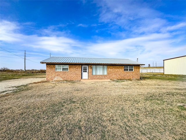 311 S Fir Ave, Munday, TX 76371 - single story home with metal roof and brick siding