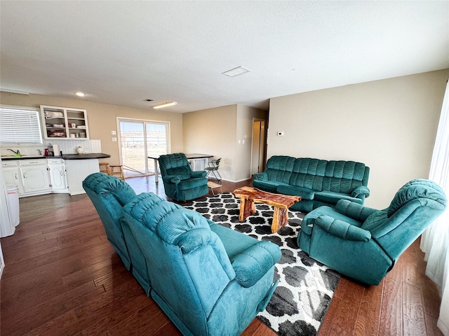 311 S Fir Ave, Munday, TX 76371 - living area with dark wood-style flooring