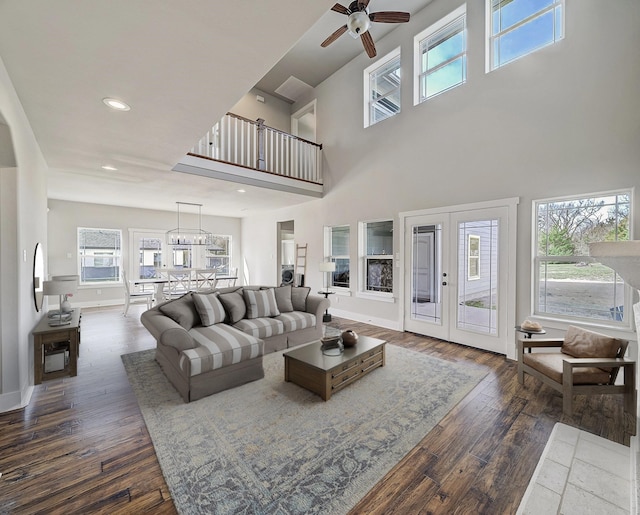 living area with recessed lighting, baseboards, a high ceiling, dark wood-style floors, and ceiling fan