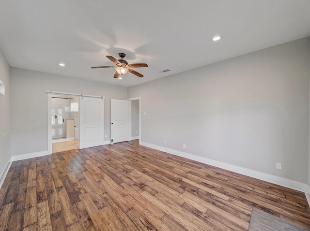 unfurnished bedroom with baseboards, visible vents, wood finished floors, and recessed lighting