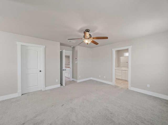 unfurnished bedroom with a ceiling fan, ensuite bathroom, baseboards, light colored carpet, and visible vents