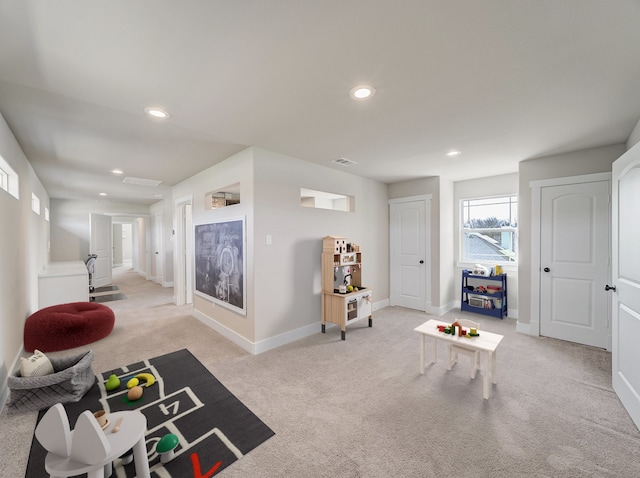 recreation room featuring light carpet, baseboards, visible vents, and recessed lighting