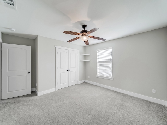 unfurnished bedroom with baseboards, visible vents, a closet, and carpet