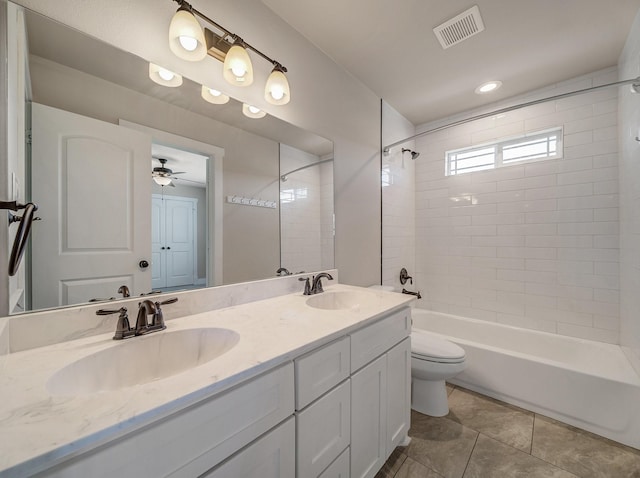 bathroom featuring toilet, a sink, shower / bath combination, visible vents, and double vanity