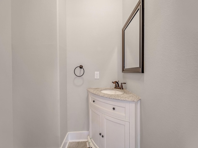 bathroom with baseboards and vanity