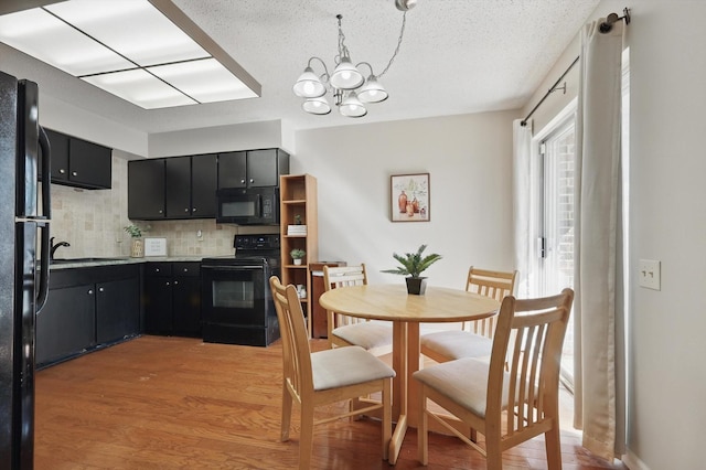 2700 Stonehaven Ct, Irving, TX 75038 - dining room featuring an inviting chandelier, wood finished floors, a textured ceiling, and a healthy amount of sunlight