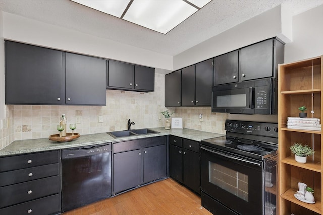 2700 Stonehaven Ct, Irving, TX 75038 - kitchen featuring black appliances, decorative backsplash, a sink, and light wood-style flooring