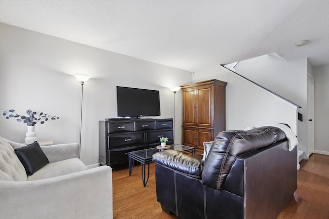 2700 Stonehaven Ct, Irving, TX 75038 - living area with light wood finished floors, baseboards, and a textured ceiling