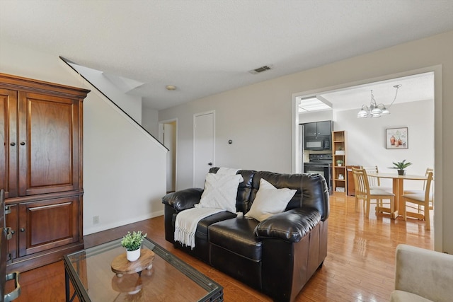 2700 Stonehaven Ct, Irving, TX 75038 - dining area with baseboards, wood finished floors, a chandelier, and a textured ceiling