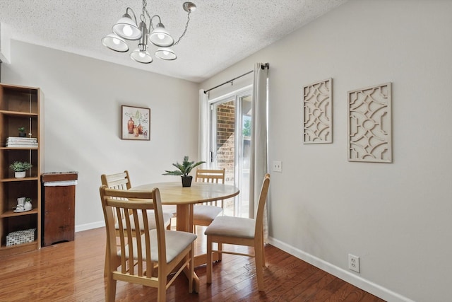 2700 Stonehaven Ct, Irving, TX 75038 - kitchen with an inviting chandelier, light wood-style floors, decorative backsplash, dark cabinets, and black appliances