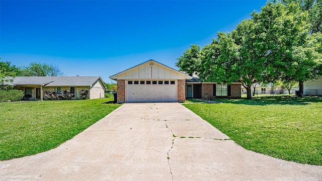 ranch-style house with concrete driveway, board and batten siding, an attached garage, a front lawn, and brick siding