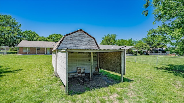 view of outdoor structure featuring fence and an outdoor structure