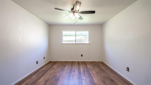 spare room featuring a ceiling fan, wood finished floors, and baseboards