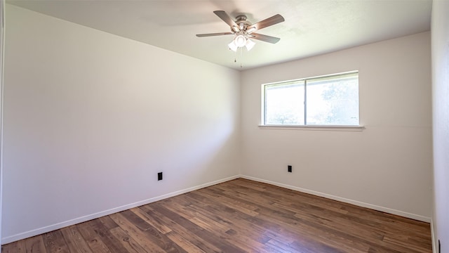 spare room featuring wood finished floors, a ceiling fan, and baseboards