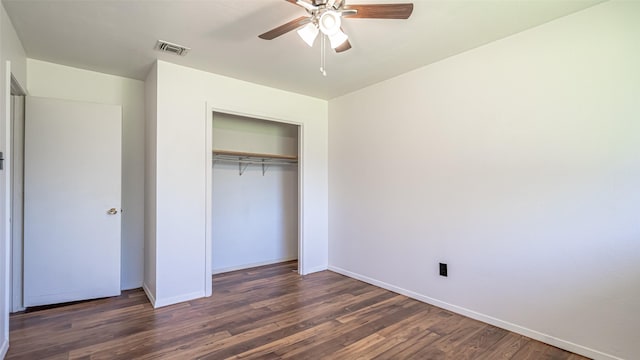 unfurnished bedroom featuring visible vents, wood finished floors, and baseboards