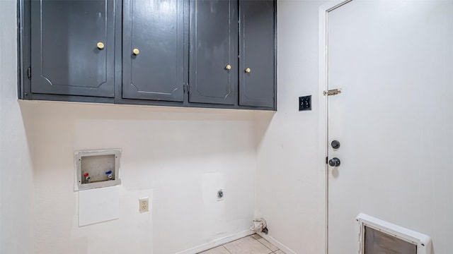 laundry room with hookup for a washing machine, light tile patterned floors, cabinet space, hookup for an electric dryer, and baseboards